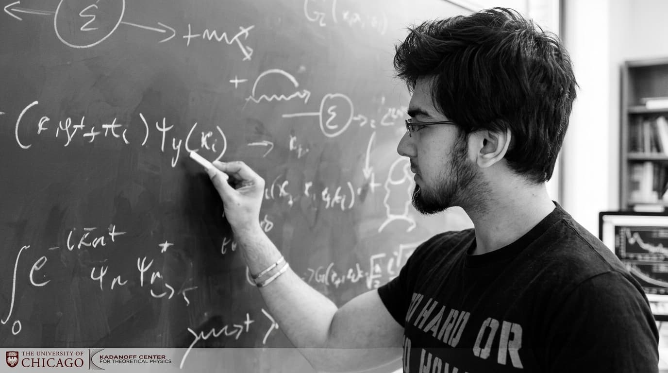 Writing equations at a chalkboard